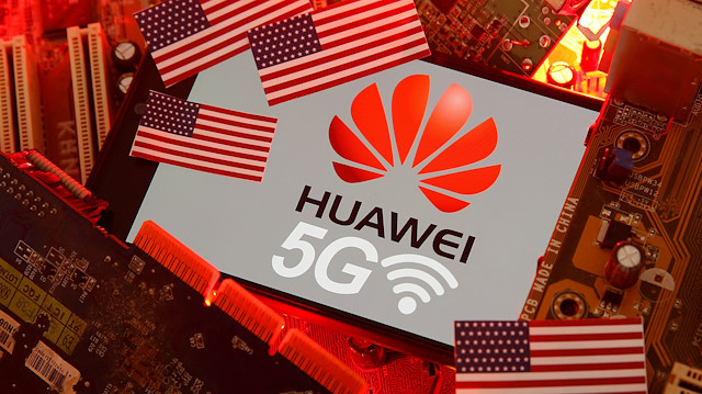 The U.S. flag and a smartphone with the Huawei and 5G network logo are seen 