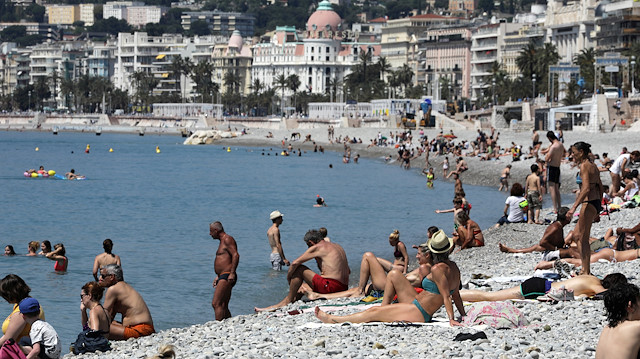 People sunbathe on a beach of the Promenade des Anglais, after France reopened its beaches to the public as it softens its strict lockdown rules following the outbreak of the coronavirus disease (COVID-19), in Nice, France, May 21, 2020. REUTERS/Eric Gaillard

