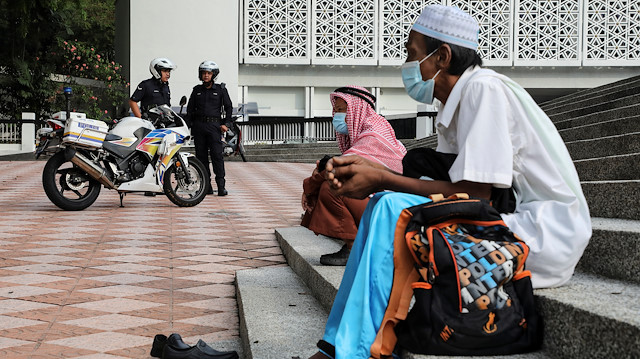 Police officers stand guard outside the closed National Mosque during Eid al-Fitr, the Muslim festival marking the end the holy fasting month of Ramadan, amid the coronavirus disease (COVID-19) outbreak in Kuala Lumpur, Malaysia May 24, 2020. REUTERS/Lim Huey Teng

