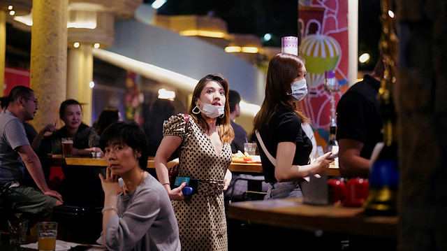 People wearing face masks are seen at a bar area in a nightclub after it reopens, following a shutdown due to the coronavirus disease (COVID-19) outbreak, in Shanghai, China May 22, 2020. Picture taken May 22, 2020. REUTERS/Aly Song

