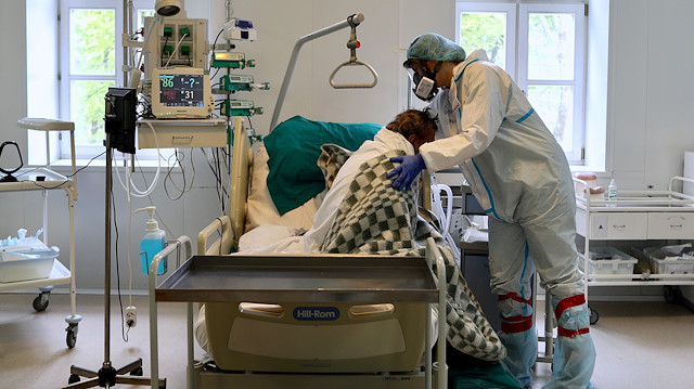 A medical specialist wearing a personal protective equipment (PPE) works in the hospital No. 1 