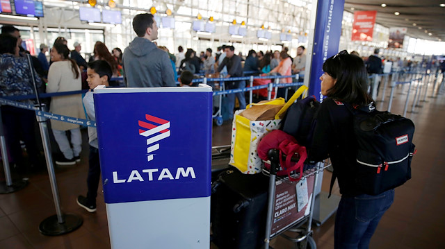FILE PHOTO: Passengers wait to check in for their flights at the departure area of Latam airlines inside of the Commodore Arturo Merino Benitez International Airport in Santiago, Chile April 25, 2019. 