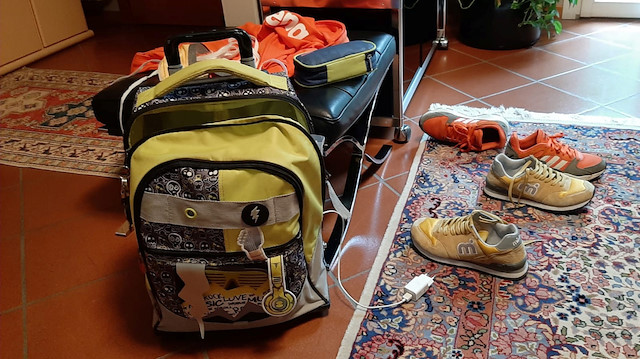 Schoolbags and shoes of two grandchildren of Paola Berardi are left at the entrance of her house, where the twins go to do their homework every afternoon, in Emilia Romagna region, Italy, May 18, 2020. Paola Berardi/Handou