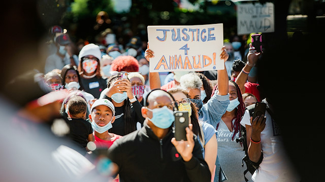 FILE PHOTO: Supporters of the Georgia NAACP (National Association for the Advancement of Colored People) wearing protective masks protest after the death in February of Ahmaud Arbery, an unarmed young black man shot after being chased by a white former law enforcement officer and his son, at the Glynn County Courthouse in Brunswick, Georgia, U.S., May 8, 2020. 