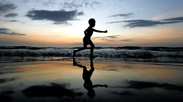 A boy is seen in silhouette as he runs on a beach in Colombo, Sri Lanka January 7, 2020. REUTERS/Dinuka Liyanawatte TPX IMAGES OF THE DAY

