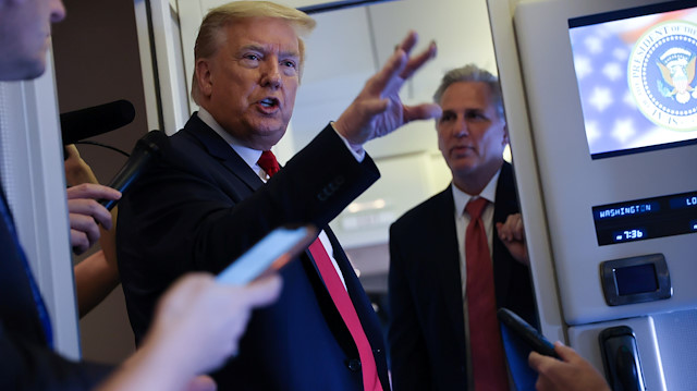 U.S. President Donald Trump, with U.S. House Minority Leader Kevin McCarthy (R-CA), speaks to reporters aboard Air Force One while returning to Washington from Cape Canaveral, Florida, U.S. May 30, 2020. REUTERS/Jonathan Ernst  