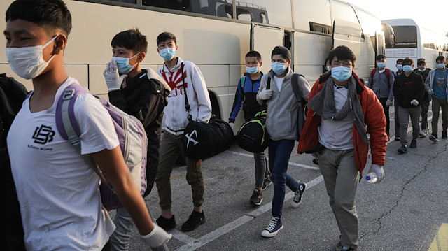 File photo: A group of unaccompanied children from overcrowded migrant camps who will be transferred to Germany and Luxembourg, wear protective face masks as a precaution against the spread of coronavirus disease (COVID-19) as they arrive at the port of Piraeus, Greece, April 15, 2020