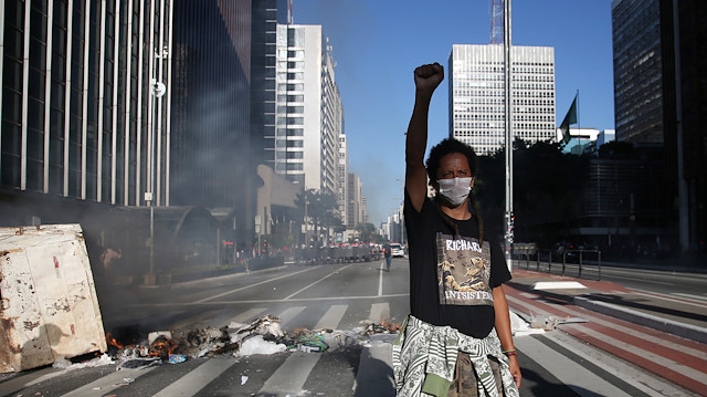 A demonstrator gestures during a protest against Brazilian President Jair Bolsonaro at Paulista avenue in Sao Paulo, Brazil, May 31, 2020.