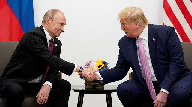 FILE PHOTO: Russia's President Vladimir Putin and U.S. President Donald Trump shake hands during a bilateral meeting at the G20 leaders summit in Osaka, Japan, June 28, 2019. 