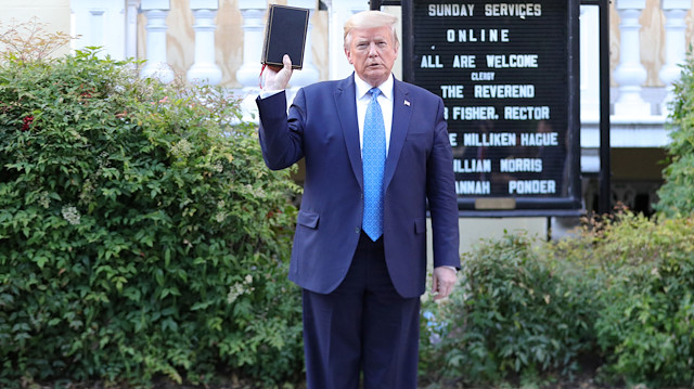 U.S. President Donald Trump holds up a Bible as he stands in front of St. John's Episcopal Church