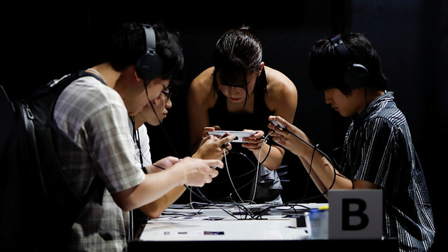 Visitors try a gaming program on Sony's Xperia smartphone at Tokyo Game Show 2019 in Chiba, east of Tokyo, Japan, September 12, 2019.