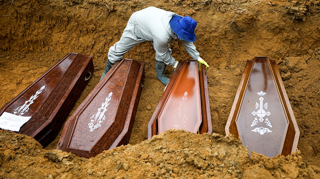 A gravedigger works during a mass burial of people who passed away due to the coronavirus disease (COVID-19), at the Parque Taruma cemetery in Manaus, Brazil May 13, 2020