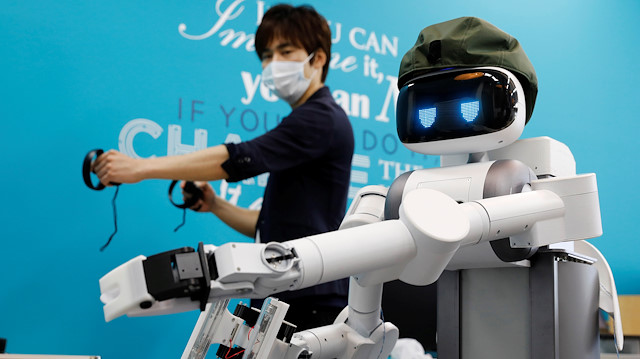 Mira Robotics CEO Ken Matsui operates an Ugo avatar robot during a demonstration at the company's laboratory in Kawasaki, Japan June 8, 2020. Picture taken June 8, 2020
