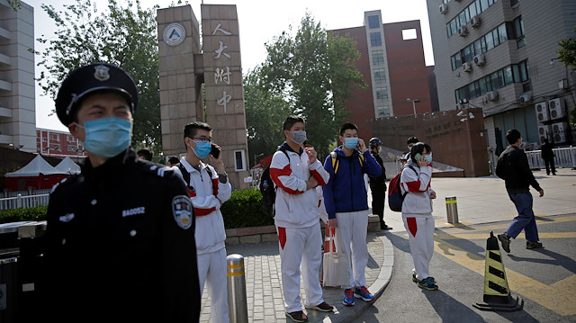 File photo: Students wearing face masks leave a school in Beijing, China as senior high school students in the Chinese capital returned to campus following the coronavirus disease (COVID-19) outbreak, April 27, 2020. 
