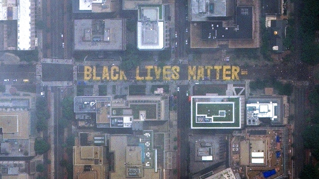 File photo: People walk along 16th Street NW with many gathering on and near the new "Black Lives Matter" lettering painted on the street in Washington, DC, U.S. in this June 6, 2020 