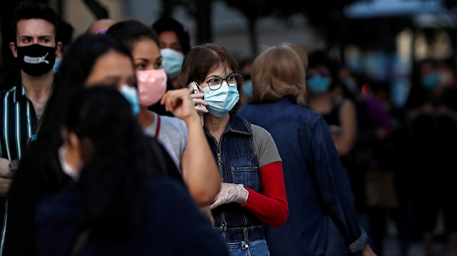 People wearing face masks queue to enter a reopened Primark store as Madrid eases lockdown restrictions following the coronavirus disease (COVID-19) outbreak, in Madrid, Spain, June 11, 2020.
