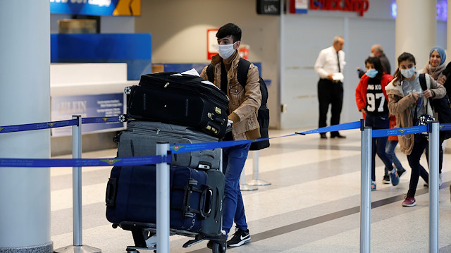A passenger wearing a protective mask pushes a trolley at Beirut's international airport as Lebanon temporarily shuts down the airport, after declaring a medical state of emergency as part of the preventive measures against the spread of coronavirus disease (COVID-19) in Beirut, Lebanon March 18, 2020. 