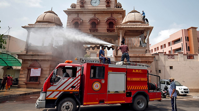 Firefighters spray disinfectant on the Lord Jagannath temple, after authorities eased lockdown 