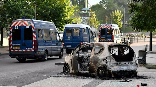 Cars were torched and wheelie bins set alight late on Monday before several dozen police managed to restore order