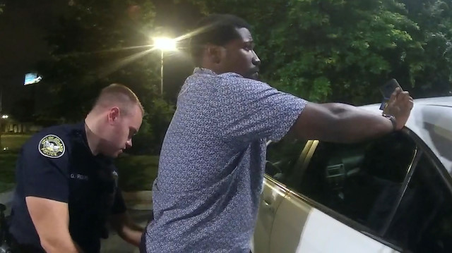 Former Atlanta Police Department officer Garrett Rolfe searches 27-year-old Rayshard Brooks in a Wendy's restaurant parking lot in a still image from the video body camera of officer Devin Bronsan in Atlanta, Georgia, U.S. June 12, 2020. Video taken June 12, 2020.