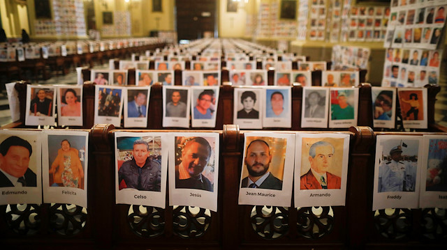 File photo: Photographs of Peru's victims of the coronavirus disease (COVID-19) are seen on the pews and walls of the Cathedral of Lima before a mass officiated by Archbishop Carlos Castillo (not pictured), in Lima, Peru June 14, 2020. REUTERS/Sebastian Castaneda 