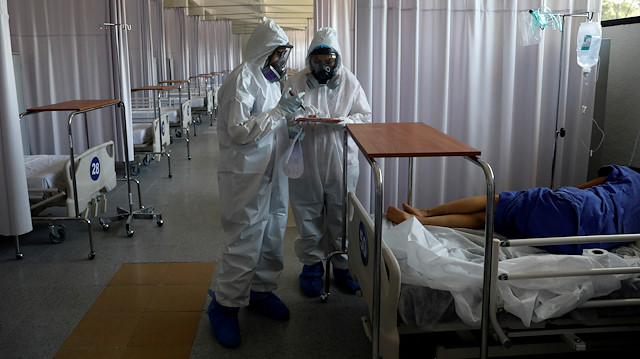 Medical staff are seen looking after a patient inside the provisional military hospital of the Campo Militar No. 1, which takes care of patients with symptoms of the coronavirus disease (COVID-19) in Mexico City, Mexico June 9, 2020