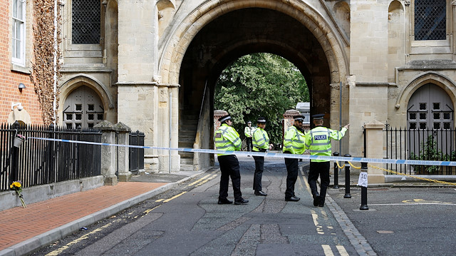 Police officers stand behind the cordon at the scene of multiple stabbings in Reading, Britain, June 21, 2020