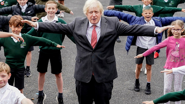 Britain's Prime Minister Boris Johnson practices COVID-19 social distancing with schoolchildren on a visit to Bovingdon Primary Academy in Hemel Hempstead, Britain June 19, 2020. Andrew Parsons/10 Downing Street/Handout via REUTERS 