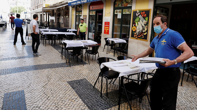 FILE PHOTO: A waiter waits for customers at a restaurant, amid the coronavirus disease (COVID-19) outbreak, in downtown Lisbon, Portugal May 25, 2020