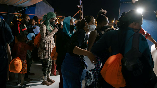 File photo: Migrants wearing face masks as a means of protection against the coronavirus disease (COVID-19) wait to disembark from the German NGO search and rescue ship Sea-Watch 3, before being transferred on board the Moby Zaza ferry to be quarantined, in the port of Porto Empledocle, Italy, June 21, 2020