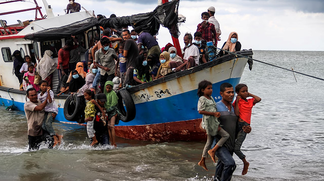 File photo: Locals evacuate Rohingya refugees from a boat at a coast of North Aceh, Indonesia, June 25, 2020 in this photo taken by Antara 