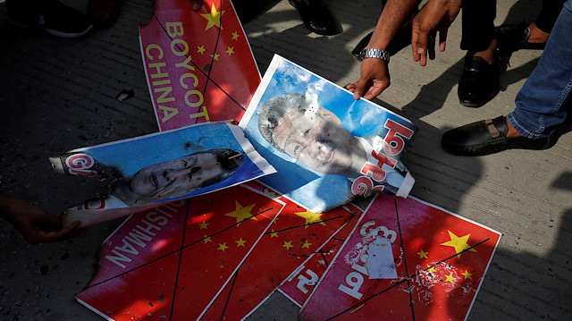 Members of National Students' Union of India (NSUI) burn posters of Chinese President Xi Jinping during a protest against China, in Ahmedabad, India, June 18, 2020. REUTERS/Amit Dave

