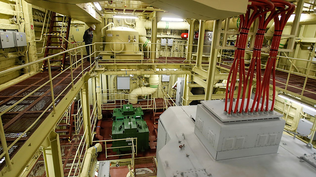 An employee looks on inside machinery compartment at floating nuclear power plant 
