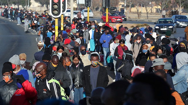 Stranded commuters wait for transportation at a bus terminal during a protest by taxi operators over the government's financial relief for the taxi industry, amid the coronavirus disease (COVID-19) lockdown, in Soweto, South Africa, June 22, 2020. 