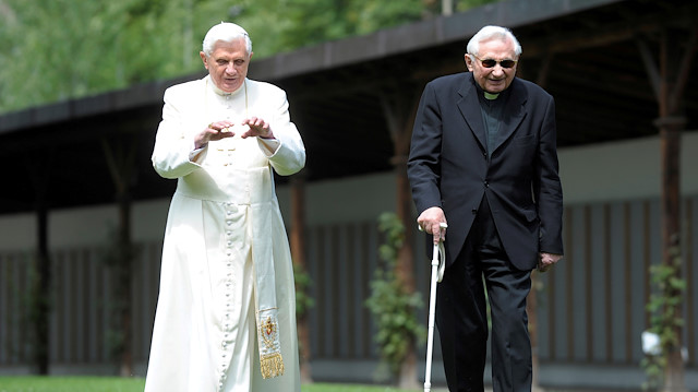 FILE PHOTO: Pope Benedict XVI strolls in a garden with his brother Bishop Georg Ratzinger during his annual holiday in Bressanone, northern Italy July 31, 2008. 