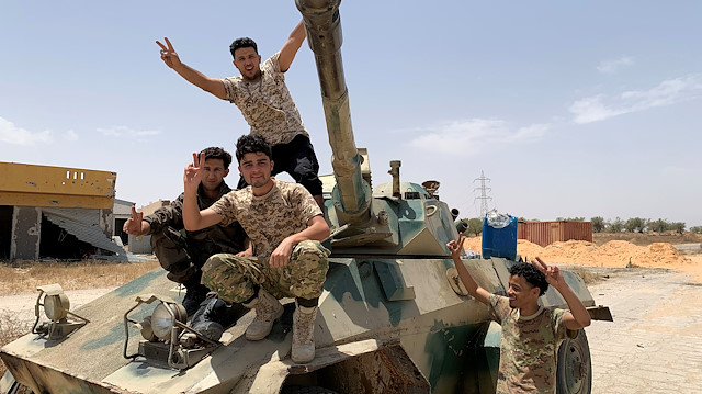 FILE PHOTO: Fighters loyal to Libya's internationally recognised government celebrate after regaining control over the city, in Tripoli, Libya, June 4, 2020. REUTERS/Ayman Al-Sahili./File Photo

