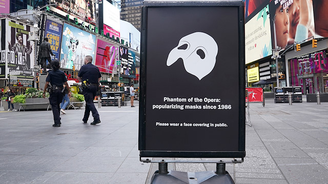 A "Phantom of the Opera" sign asks people to wear a mask in public, as coronavirus disease (COVID-19) outbreak continues, in the Manhattan borough of New York City, New York, U.S., June 29, 2020. REUTERS/Carlo Allegri

