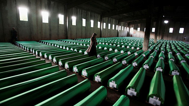 A Bosnian Muslim woman searches coffins in Potocari, near Srebrenica