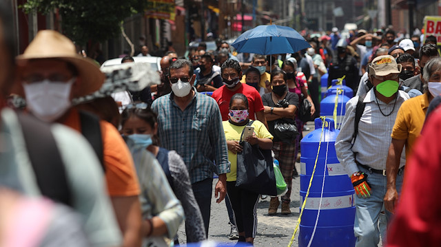 File photo: People wait in line along the street before entering the area where stores are open, during the gradual reopening of commercial activities in the city, as the coronavirus disease (COVID-19) outbreak continues, in Mexico City, Mexico July 6, 2020