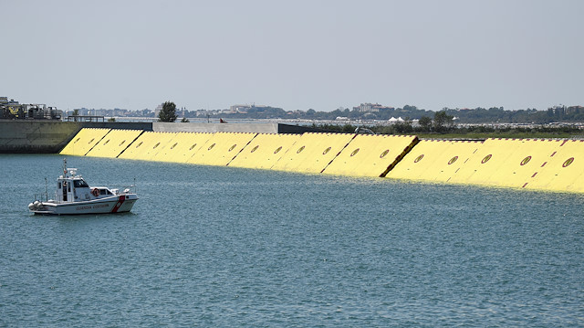 Yellow mobile barriers are seen above the surface of the water during tests of flood barrier project Experimental Electromechanical Module (Mose) in Venice, Italy, July 10, 2020