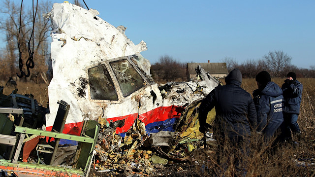 FILE PHOTO: Local workers transport a piece of wreckage from Malaysia Airlines flight MH17 at the site of the plane crash near the village of Hrabove (Grabovo) in Donetsk region, eastern Ukraine, November 20, 2014