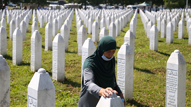 A woman is seen at a graveyard, ahead of a mass funeral in Potocari near Srebrenica, Bosnia and Herzegovina July 11, 2020. Bosnia marks the 25th anniversary of the massacre of more than 8,000 Bosnian Muslim men and boys, with many relatives unable to attend due to the coronavirus disease (COVID-19) outbreak. 