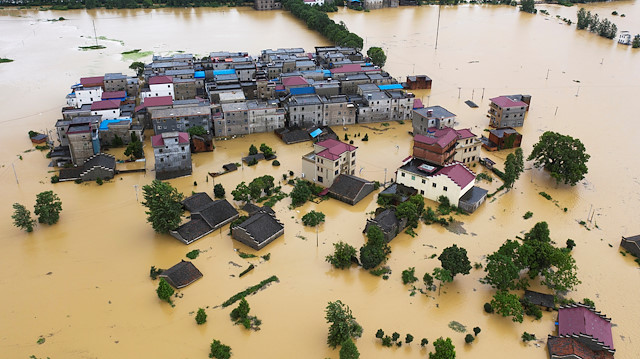 An aerial view shows buildings and farmlands partially submerged in floodwaters following heavy rainfall in Duchang county, Jiangxi province, China July 8, 2020