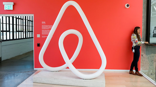 FILE PHOTO: A woman talks on the phone at the Airbnb office headquarters in the SOMA district of San Francisco, California, U.S., August 2, 2016. 