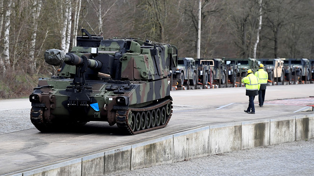 FILE PHOTO: Soldiers of German Army Bundeswehr load a U.S. M109 tank onto a heavy goods transporter during preparations for the Defender-Europe 20 international military exercises in Bergen Hohne, Germany, February 12, 2020. 