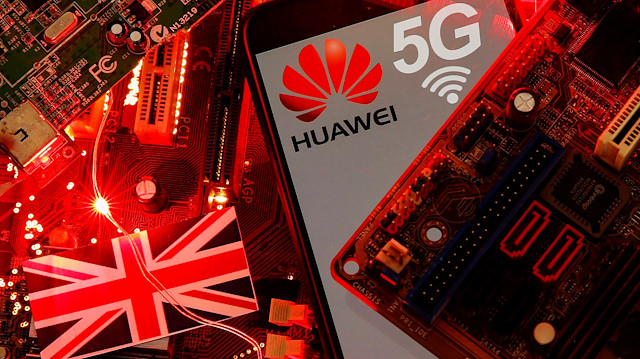 The British flag and a smartphone with a Huawei and 5G network logo 