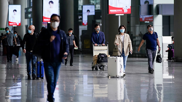 FILE PHOTO: People wearing face masks are seen at Hongqiao International Airport in Shanghai, following the coronavirus disease (COVID-19) outbreak, China May 21, 2020