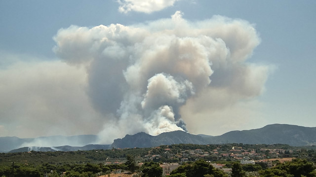Smoke rises as a wildfire burns near the village of Kechries, Greece, July 22, 2020.