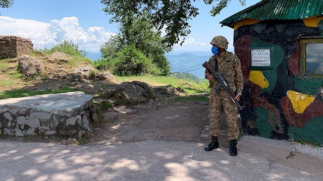Pakistan Army soldier stands guard at a hilltop post during a trip organised by the army, near the Line of Control (LoC), in Charikot Sector, Kashmir July 22, 2020. Picture taken July 22, 2020. REUTERS/Charlotte Greenfield


