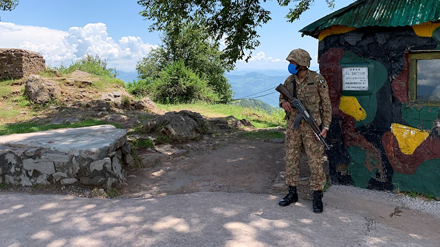 Pakistan Army soldier stands guard at a hilltop post during a trip organised by the army, near the Line of Control (LoC), in Charikot Sector, Kashmir July 22, 2020. Picture taken July 22, 2020. REUTERS/Charlotte Greenfield